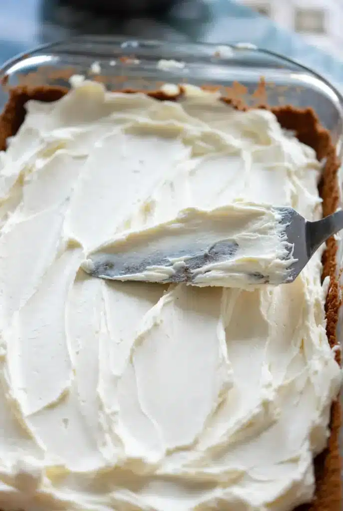 Creamy cheesecake layer spread smoothly over the crust