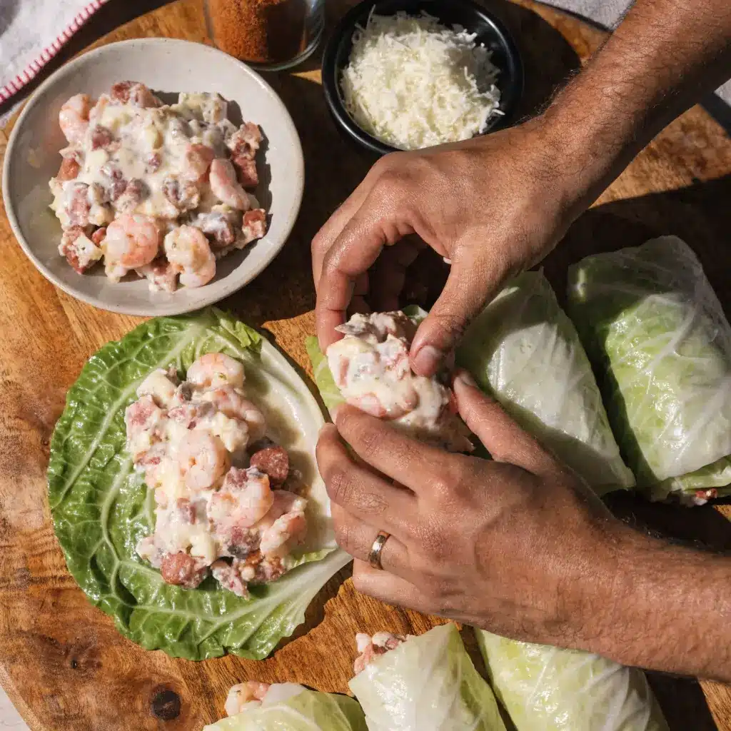 Rolling Keto Cajun Shrimp Sausage Stuffed Cabbage leaves