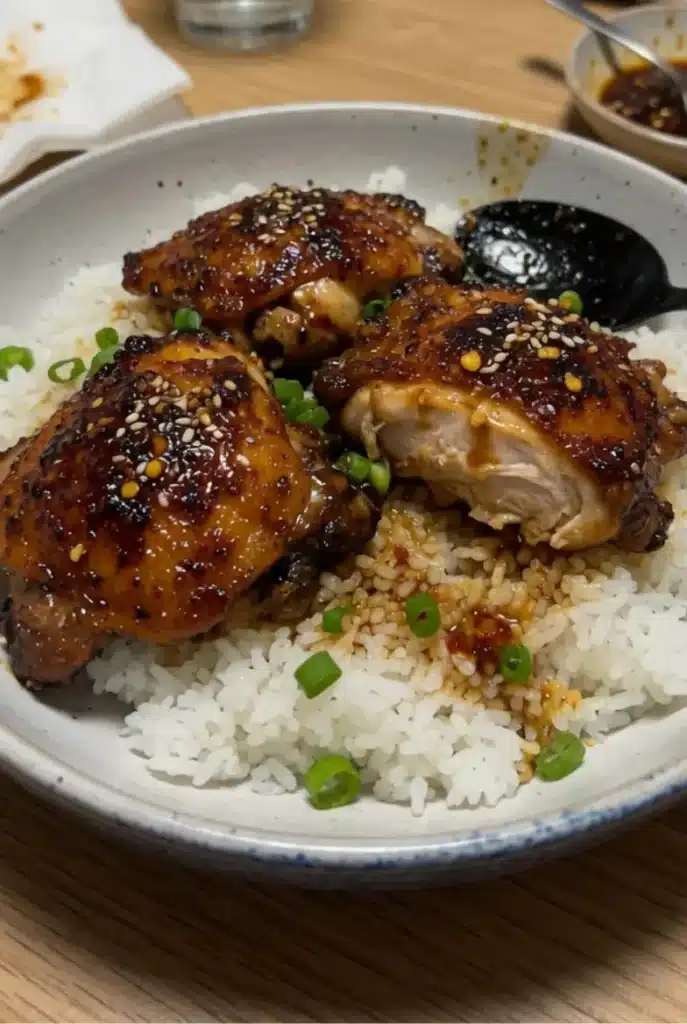 Honey Garlic Chicken Thighs served with sauce and garnish