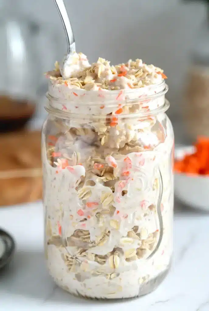 oats and grated carrots mixed with milk and spices in a jar