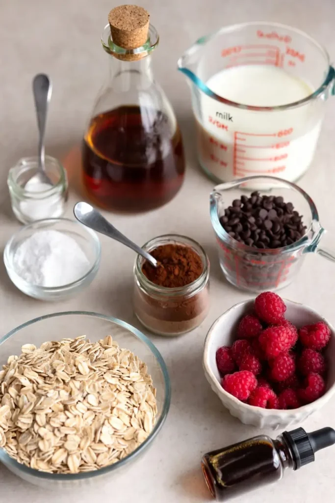 oats, raspberries, cocoa, and baking ingredients arranged on surface