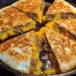 Mouthwatering Cheeseburger Quesadillas with Burger Sauce 10 Golden toasted tortilla wedges filled with melted cheese and savory beef served with a creamy dipping sauce