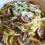 Creamy mushroom pasta with garlic parmesan sauce served in a rustic bowl