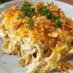 Warm baked casserole served on a plate with creamy filling and crispy topping